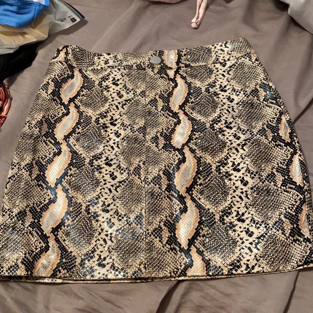 Size small skirt. Never worn. Snake print. Leather